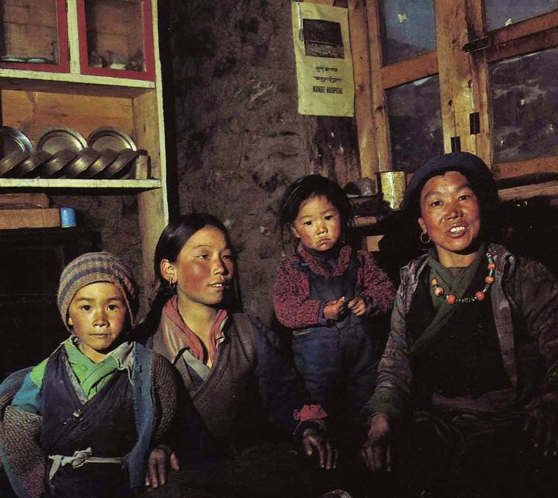 a. Photograph of four Tibetans in their home. b. Photograph of Mount Everest.

