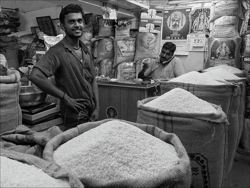 Many varieties of rice being sold in a shop in India.
